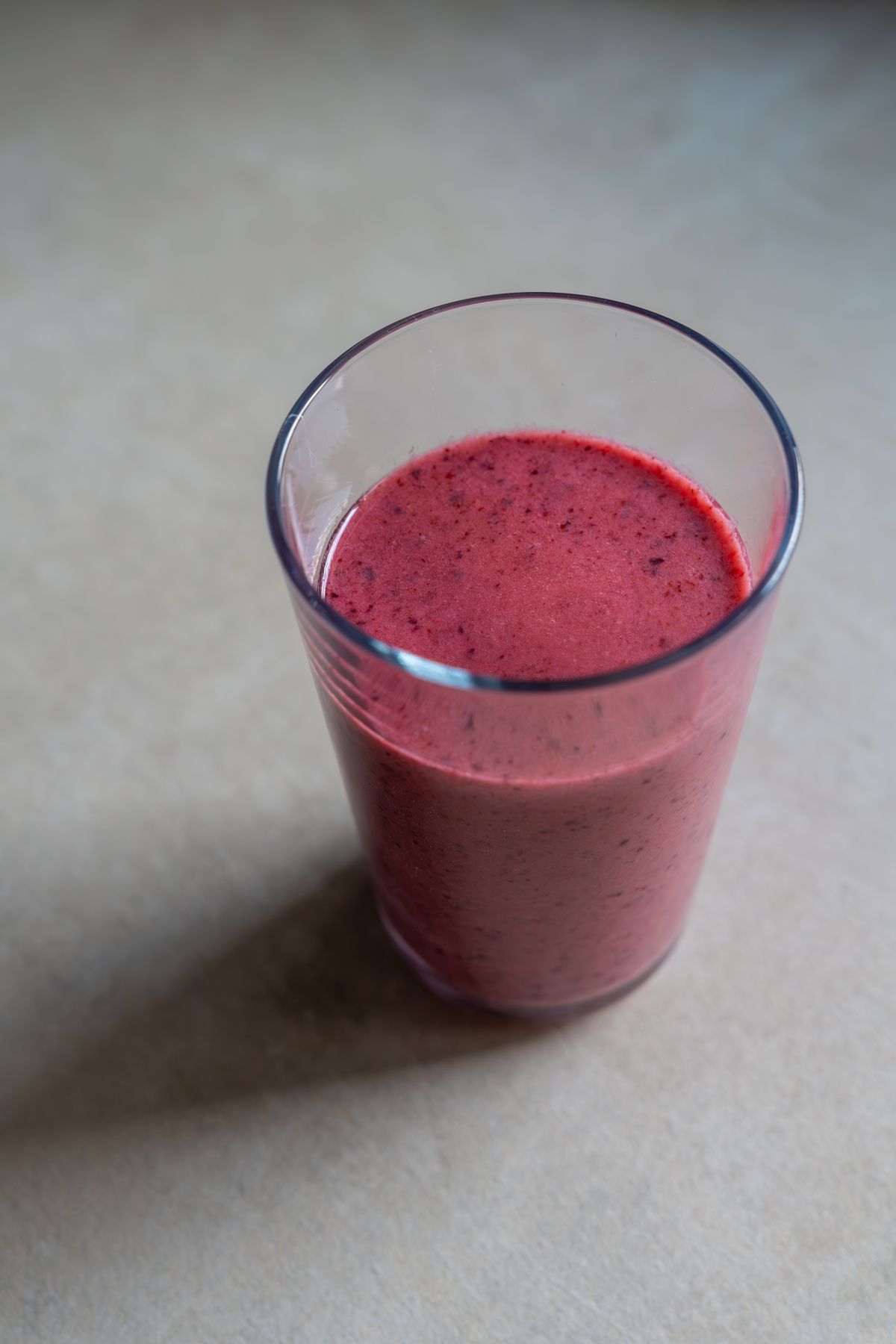 A freshly made berry drink in a glass