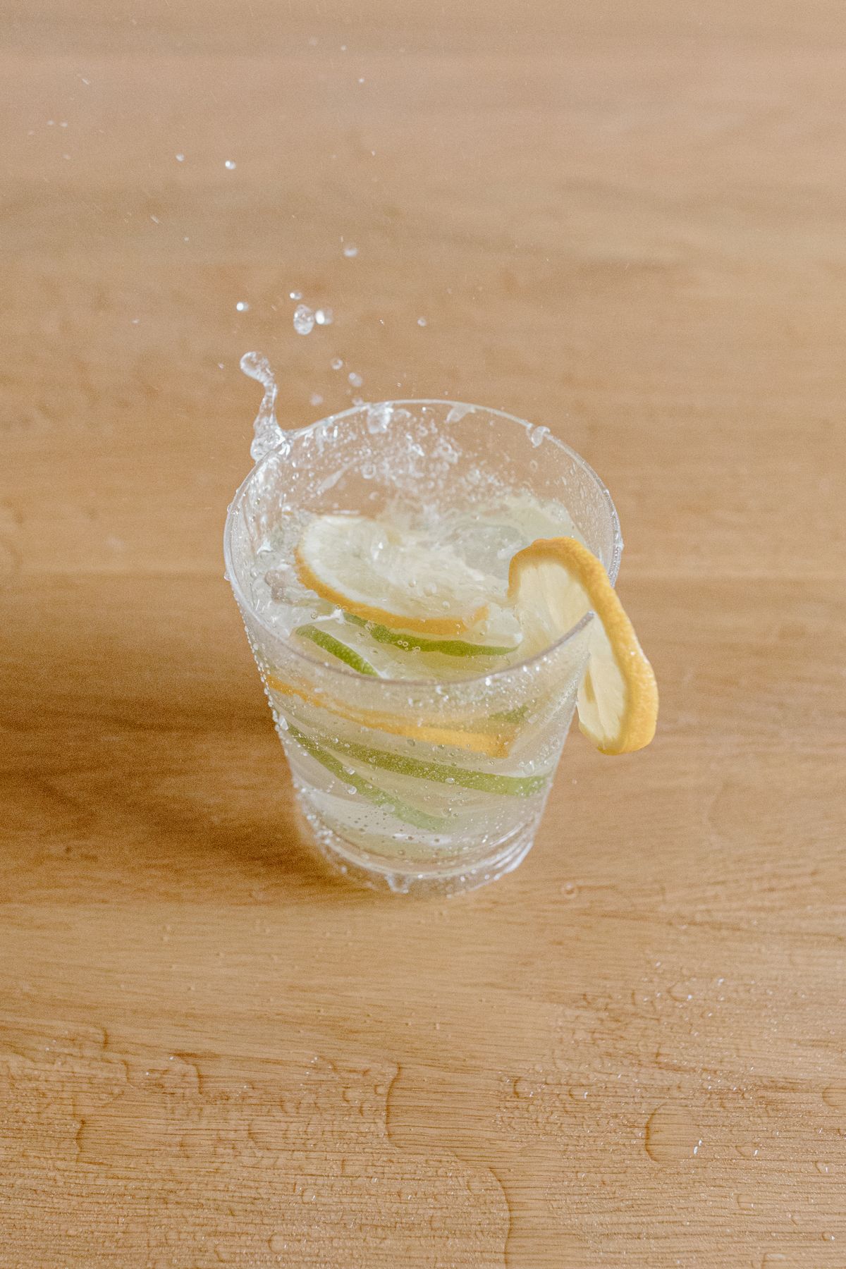 A glass of water with lime slices